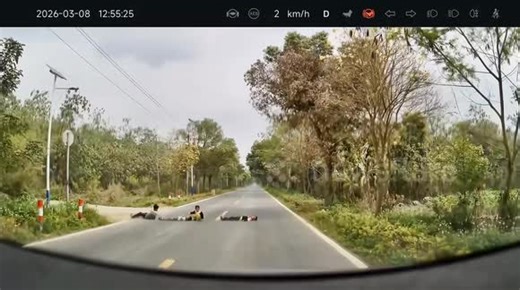 Children lying in road narrowly avoid being run over as car forcefully brakes