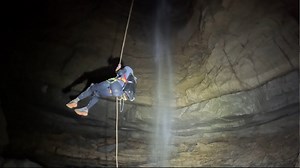 Rappelling 280 Feet Down a Waterfall in a River Cave