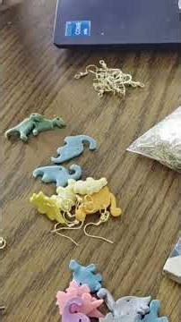 making dino earrings that are live on my website now. artbyashleyparent.squarespace.com