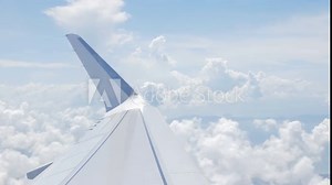 view through airplane aircraft window with wing view while flying in sky over puffy cloudy in sunny day,Airplane Wings with blue sky travel vacation holiday travel background