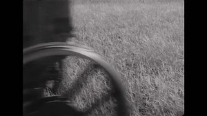 clip-1099996505-1930s-man-drives-tractor-through-field-pulls