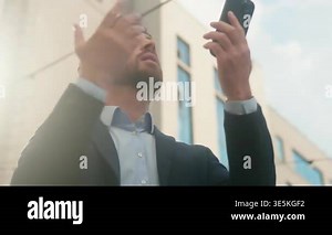 Confused stressed Caucasian business man checking smartphone no signal outside city middle aged unhappy male 40s businessman employer searching mobile phone network wifi problem error connection fail Stock Video Footage - Alamy