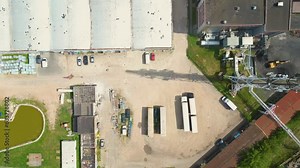 Territory of the coal terminal with coal dumps and a regenerator. loading and unloading of coal by excavators and belt conveyors. coal reserves at thermal power plants. View from above
