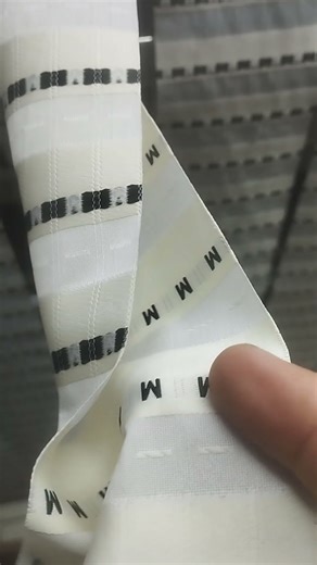 ''Woven label, machine during size label production ''