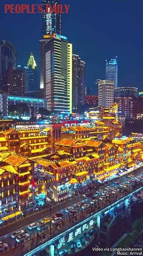 As night falls, the stilted buildings of Hongyadong in SW China's Chongqing awaken in golden lights.