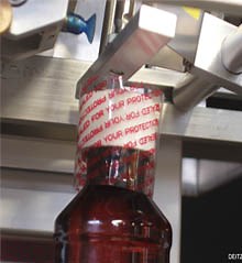 Neck Bander Automatically Applies Tamper-Evident Bands to Bottles