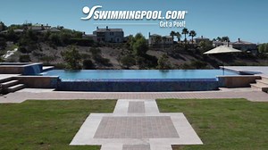 Water cascades over parallel infinity edges decorated with NPT Lightwaves Blue 2x2 pool tile. Explore the Lightwaves line at nptpool.com/tile/lightwaves/ | SwimmingPool.com | Facebook