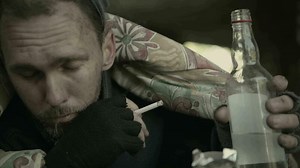 Drunk Caucasian Homeless Men Drinking Alcohol Inside His Shelter