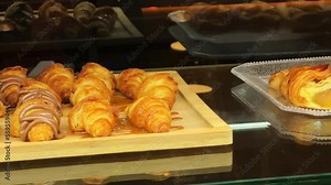 Display window with pastry - croissant in showcase. High quality 4k footage