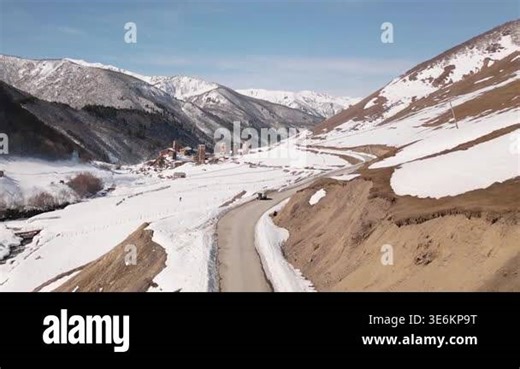 Aerial view Ushguli Svaneti mountain road, winter snowbanks, Caucasus peaks, remote village access, scenic road trip, adventure travel, alpine landscape, rural infrastructure Stock Video Footage - Alamy