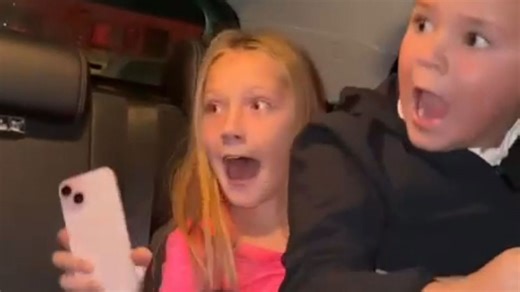 Kids scream loudly as an eerie figure jumps into their car at horror car wash