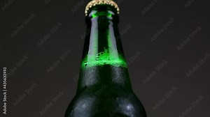 Closeup the beers bottle is made of green glass, rotating 360 degrees.