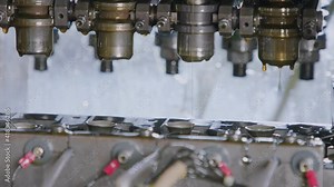 Close up of a punch press forming metal parts in a production line