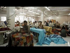 Timelapse of factory workers using sewing machines in a garment factory, Rajasthan, India