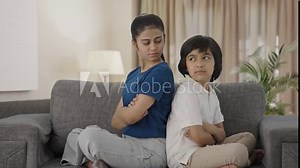 Angry Indian siblings sitting back to back and not talking