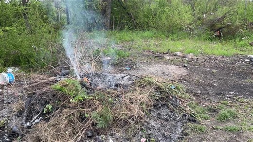 Burning heap of waste, dispose, dump. Garbage, litter smoulders