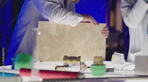 Professional scientists in white coats working inside modern futuristic laboratory . Construction experts doing experiment . Physician or seismologist working inside lab . Concept of quality checking