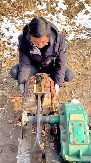 Man splitting firewood using mechanical wood splitter outdoors safely