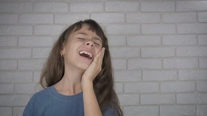 Child crying because of toothache. Child suffering a lot.