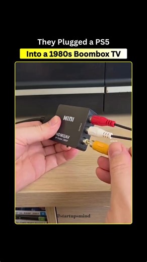 @startups._mind on Instagram: "Modern PS5 works on a vintage boombox TV 📺🎮 This setup connects a brand-new PlayStation 5 to a small CRT screen built into an old 1980s boombox. Even though these devices come from totally different tech eras, they can still work together. The PS5 sends out a clean digital video signal, which is then changed using special adapters into an old-style analog signal that the CRT screen understands. That tiny screen was never made for high-resolution gaming, but the s