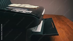 Print on a counterfeit one hundred dollar bill. Fake money, illegal actions. Illegal printing of money. American dollars print on A4 sheet.