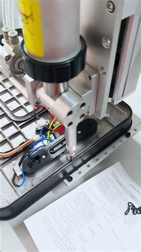 The dispensing machine precisely dispenses adhesive onto the bottom of the baking tray.