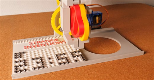 mechanical marble clock moves steel balls into pixel-like digits to tell the time