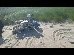 Beach Cleaner hydraulic drum drive removing plastics and debris from beach