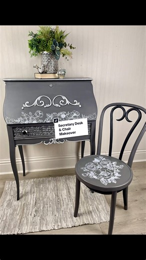 This poor secretary desk was sitting in the back corner of an antique store, broken and forgotten. It was honestly on its way to the landfill, but I knew I could save it! 🤗 After a huge amount of prep work, sanding, and priming, I gave the desk an all over paint job with a dark grey chalk paint. To add some beautiful details, I added a white decor transfer from @Redesign with Prima®️ which looked perfect! To accent the gorgeous accents that were already on this piece, I first applied black wax 