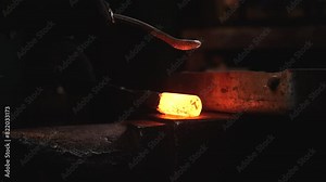 Blacksmithing is traditional craft. plant for production of non-ferrous metals. Blacksmith shop. hand-made forge. blacksmith makes iron products and cleansed red-hot iron from scale