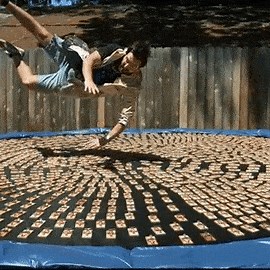 Watch a man dive into 1,000 mousetraps on a trampoline in slow motion and punch the air with joy