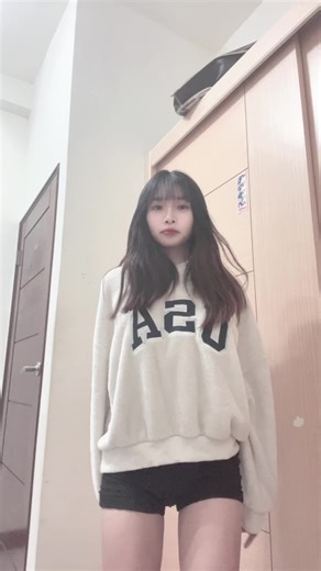 Playful Dance Performance in Oversized Sweatshirt