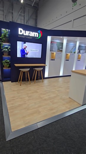 A stand for paint must be flawless. We used MDF throughout, relying on its smooth surface to achieve that high-quality, two-tone roller paint finish. Note the sophisticated contrast from the Oak Veneer counter top and shelves. The key to the depth? Fluted Polycarbonate Sheets paired with integrated LED lighting in the back wall. Clean, custom, and built to show off the product's quality. #CustomFabrication #DuramPaint #MaterialScience #PrecisionBuild #TradeShowDesign #CapeCustoms | Cape Customs