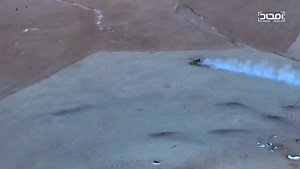 Drone footage of a tank commanded by fighters of Hayat Tahrir al-Sham storms towards ISIS positions crushing one fighter before making a rapid right turn and crushing another. Hama, 2017. Music added by source.