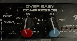 A man adjusts a vocal compressor in a recording studio. Close-up of his hand, an unrecognizable person