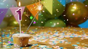 Happy birthday, one year old child copy of space. Beautiful happy birthday background number 1, birthday cupcake screensaver with candles, sparklers and falling confetti decorations