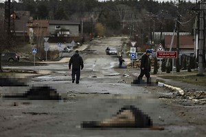 Bodies strewn on roads after Russians retreat with ‘hundreds in mass graves’