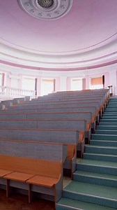 Download Beautiful conference hall with empty seats. Modern auditorium with wooden desks for lectures. Spacious university classroom without people. Vertical for free