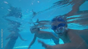 children are swimming in the pool, 4k shooting under water