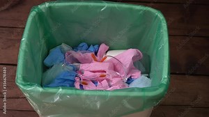 Used face masks and gloves throwaway in trash can. Plastic pollution after the COVID-19 pandemic. Disposing medical waste, shoe covers, alcohol wipes, empty plastic bottles of sanitizers