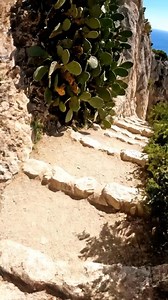 In Italy, this monumental natural stone arch creates a secret gateway to a hidden beach, where the turquoise sea flows through a massive rock opening into a secluded, emerald-green lagoon. #travel | Italy Hidden Gems