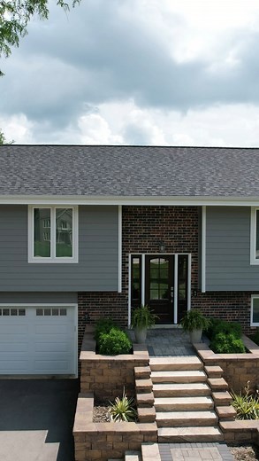 Fresh, modern, and built to last! 👏 This home got a full upgrade with LP SmartSide 8” lap siding in Pelican, crisp white trim, and a CertainTeed Northgate roof in Moire Black for a bold contrast. We completed the transformation with white gutters, a ProVia entry door, and Sunrise patio and windows for lasting beauty and efficiency. #SidingUnlimited #HomeTransformation | Siding Unlimited