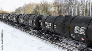 Freight train with oil tank wagons foolish with the crude oil and diesel petrol rides on the railroad at the winter. Transportation of the oil residue and diesel fuel to the refinery plant, 3d render.