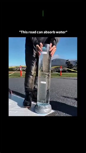 Knowledge | Curiosity | Discovery on Instagram: "The visual action documents a controlled scientific demonstration where a large, calibrated cylinder of water is rapidly poured onto a specialized road surface material, with a timer indicating the near-instantaneous and complete absorption of the liquid into the pavement. The content's utility appeal is exceptionally high, showcasing a novel, highly efficient engineering solution to critical urban problems like flash flooding, hydroplaning risk, 