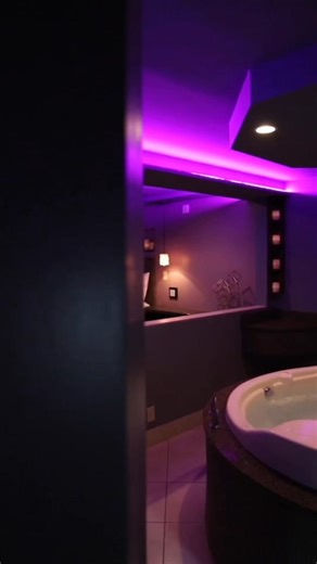 Meet Lotus. Dim light. Fire glow. A spa tub for two and a mirrored king bed. Intimate, a little daring, and made for long nights that turn into later checkouts. Once you’re in, you won’t be in a hurry to leave. | Ambiance Suites