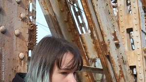 Problems in adolescence. A young girl with bad thoughts on an old bridge.
