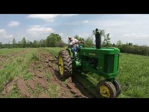 1953 John Deere 60 plowing a rough field