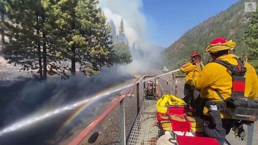 Firefighters battle wildfire from roof of moving train