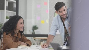 A team of analysts and developers is discussing computer and phone programs for applications and artificial intelligence. Showcasing ideas from an international team in a modern conference room.