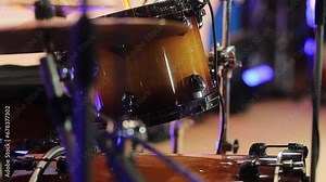 Professional drum kit on stage, drums close-up. Professional drum kit close-up. Drum kit closeup. Slow motion. Multi-colored stage lighting. Rock or jazz concert. horizontal orientation video